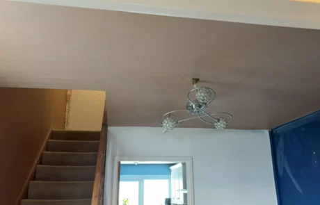 Freshly plastered stairwell wall drying out in a Lancaster house